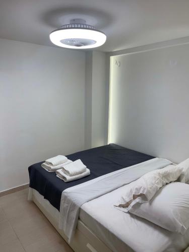 a bedroom with a bed with towels on it at Casa Maria-Anneta in Kalyves Poligirou