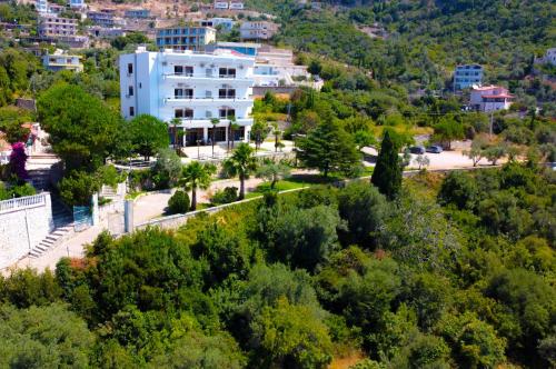 an aerial view of a city with a white building at Hotel Palasa in Palasë