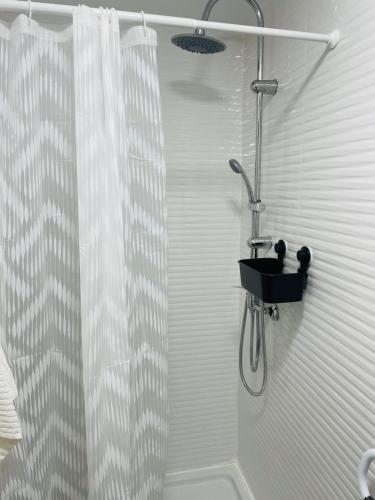 a shower in a bathroom with a shower curtain at AS ROOMS Alicante in Alicante