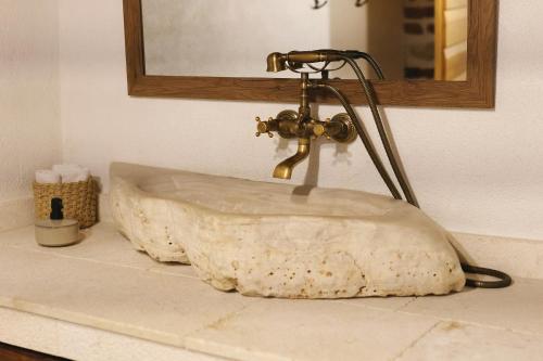 a stone sink sitting on top of a bathroom counter at Villa Romantika Dalmacija in Nin