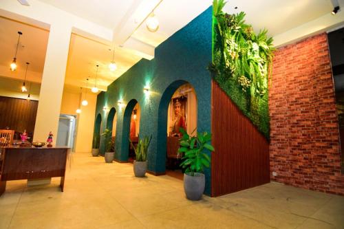 a lobby with plants on the walls and a restaurant at Green View Peak Restaurant in Gampola