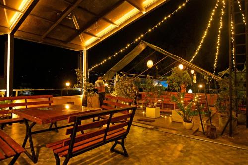 a patio with a table and chairs and lights at Green View Peak Restaurant in Gampola
