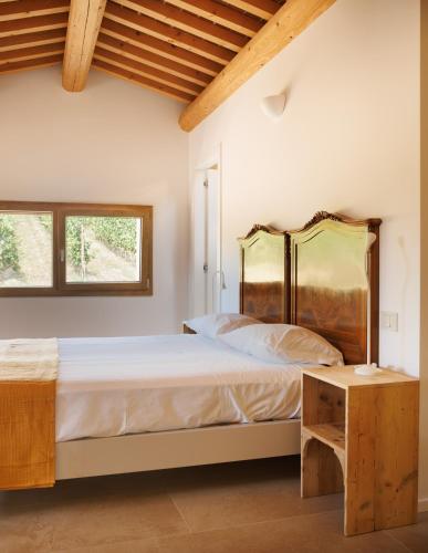 a bedroom with a large bed and a table at Agriturismo Castel Bricon in Lonigo