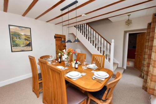 a dining room with a wooden table and chairs at High Houses in Wath