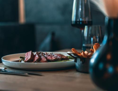 a plate of meat and pretzels on a table at Hotel Alpenkönig in Oberstaufen