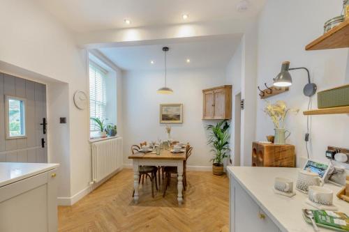 a kitchen with a table and a dining room at Wayside in Carperby