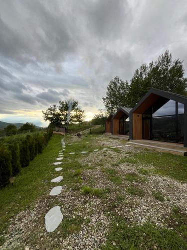 a house on a hill with a gravel road at The Landscape Barn Homes in Râşnov