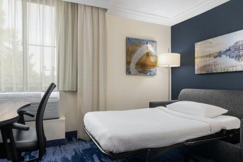 a hotel room with a bed and a desk at Fairfield by Marriott Inn & Suites Herndon Reston in Herndon