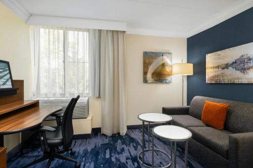 a living room with a couch and a table at Fairfield by Marriott Inn & Suites Herndon Reston in Herndon