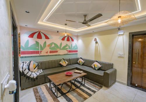a living room with a couch and a table at Boutique Apartments By One Tree in Jodhpur
