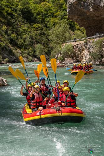 a group of people are rafting on a river at Adventure Forest in Castellane