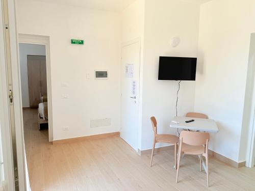 a room with a table and two chairs and a tv at Casa Ferrante in Cinisi