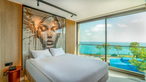 a bedroom with a large bed and a large window at Sulara Exclusıve Hotel Lounge Bistro in Antalya