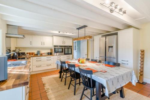 a kitchen with a table and chairs in a kitchen at Seata Barn in Askrigg