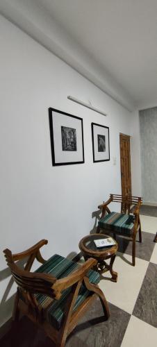 a living room with two chairs and a couch at The Hill Crest, Fagu in Shimla