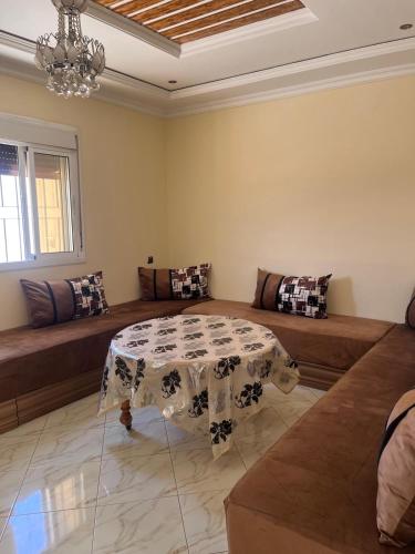 a living room with a table and a couch at 3 Chaaban 1, 1136 in Larache