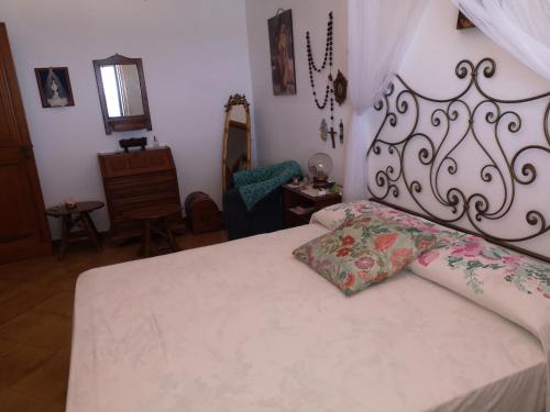 a bedroom with a white bed with a white bedspread and a bed sqor at Villa Adele in Trappeto