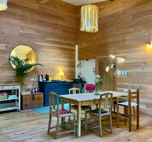a dining room with a table and chairs at Molinot Gîtes Nature & Confort in Alboussière