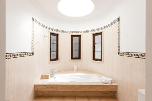 Los VallesにあるBellavista, piscina privada climatizada y saunaの白いバスルーム(バスタブ、窓付)