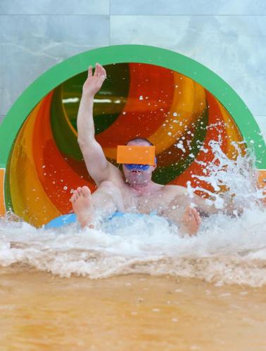 a child in the water in front of an inflatable ball at Hotel i Apartamenty Gorzelanny Dźwirzyno in Dźwirzyno