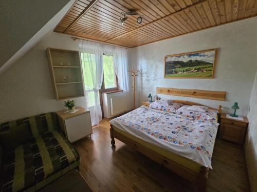 a bedroom with a large bed and a window at Penzion pod Tatrami in Ždiar