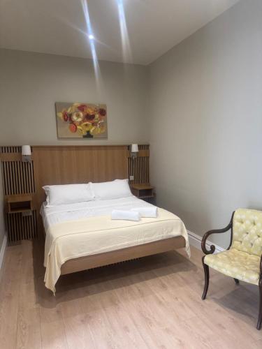 a bedroom with a bed and a chair at Milton on The Moyle Apartments in Buncrana