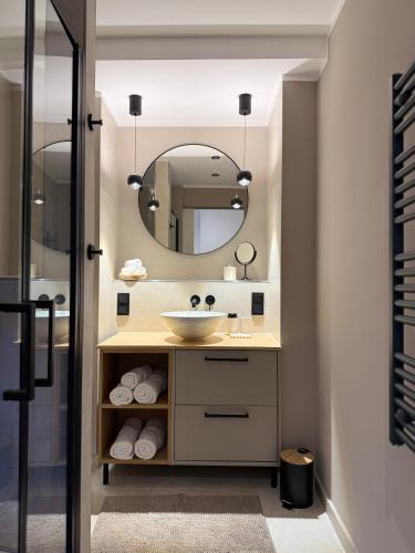 a bathroom with a sink and a mirror at 3Liebenauer Boutique Apartments in Worms