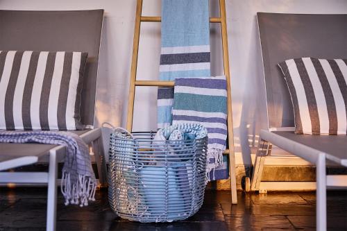 two chairs and a table with towels and baskets at Boord Guest House in Stellenbosch