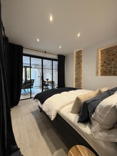a bedroom with a large bed and a balcony at 3Liebenauer Boutique Apartments in Worms