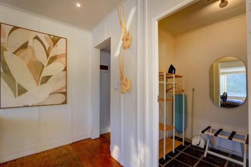 a hallway with white walls and a mirror at Casa Dal Mare in Knysna