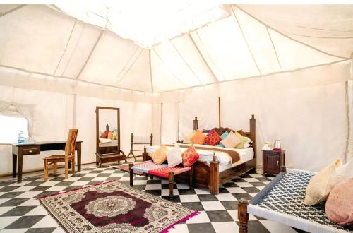 a bedroom with a bed in a tent at The Desert Gateway Resort in Jaisalmer