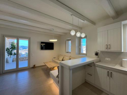 a kitchen and living room with a couch and a table at Sohoro Villas in Koufonisia