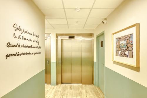 a hallway with a elevator in a building at B&B HOTEL La Réunion Aéroport in Sainte-Marie