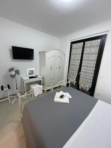 a bedroom with a bed and a desk and a window at CASA NINA affittacamere in Camerino