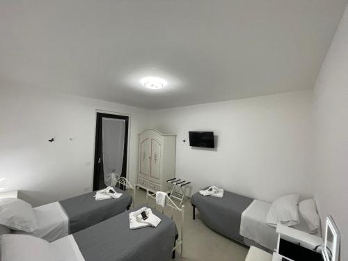 a hospital room with two beds and a mirror at CASA NINA affittacamere in Camerino
