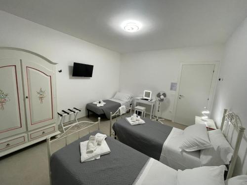a hospital room with two beds and a tv at CASA NINA affittacamere in Camerino