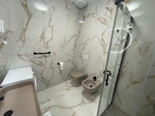 a bathroom with a toilet and a sink at CASA NINA affittacamere in Camerino