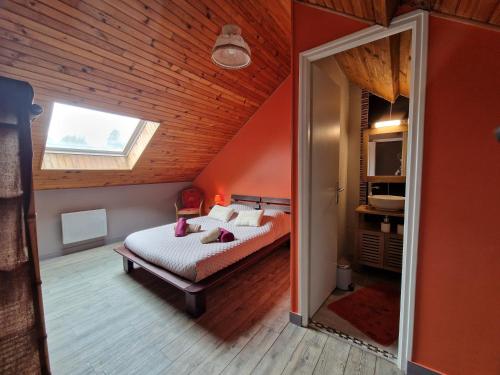 a bedroom with a bed in a room with a window at gites de l'archange in Courtils