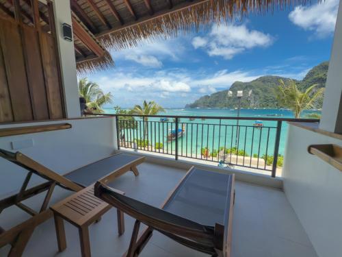 a room with a balcony with a view of the ocean at Phi Phi at Pier in Phi Phi Don