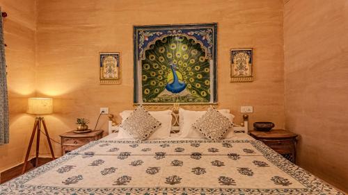a bedroom with a bed and a painting on the wall at The Castle View Homestay in Būndi
