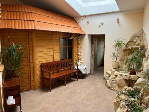 a wooden bench in a room with a stone wall at Lomnice nad Popelkou v srdci českého ráje in Lomnice nad Popelkou