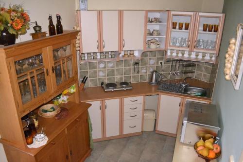 a small kitchen with white cabinets and a sink at Lomnice nad Popelkou v srdci českého ráje in Lomnice nad Popelkou