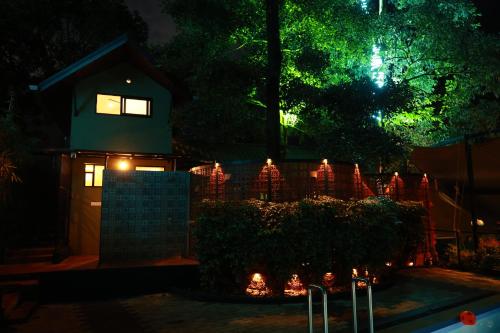 a house decorated with christmas lights at night at Swiss Holidays in Pinangode
