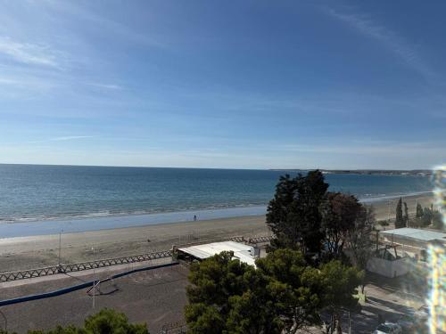 a view of a beach with a bus on it at Crystal al mar in Puerto Madryn