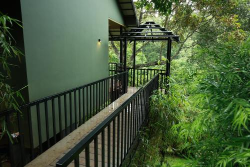 a balcony of a house with a gazebo at Swiss Holidays in Pinangode