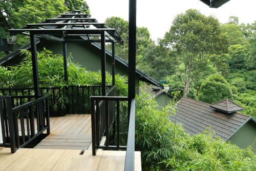 a deck with a view of a house at Swiss Holidays in Pinangode