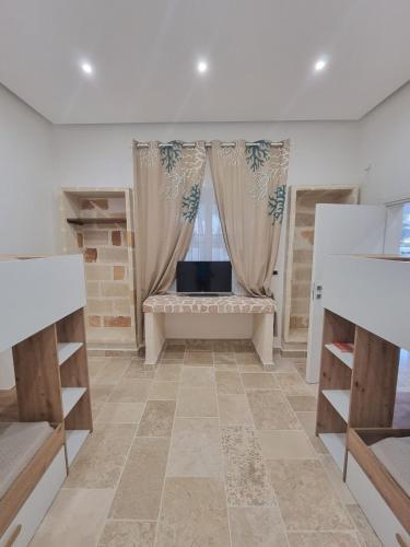 a living room with a couch and a window at Villa Zagara Pool e Sea in San Pietro in Bevagna