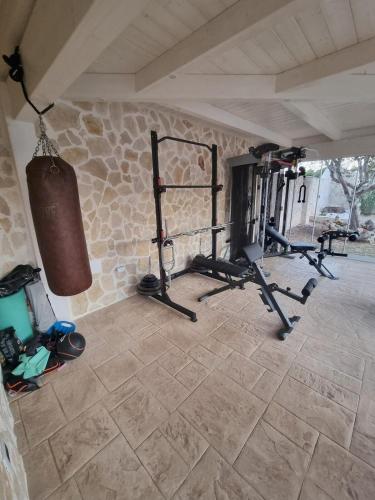 a gym with a punching bag and weights in a room at Villa Zagara Pool e Sea in San Pietro in Bevagna