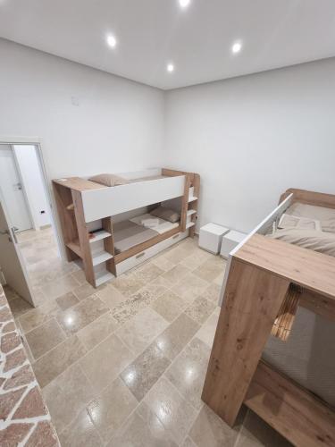 a room with a bed and a table in it at Villa Zagara Pool e Sea in San Pietro in Bevagna