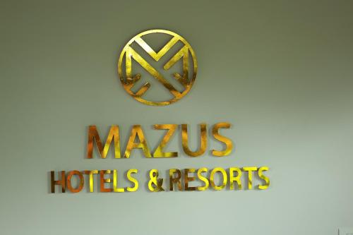 a sign for the mgm hotel and resorts logo at Swiss Holidays in Pinangode